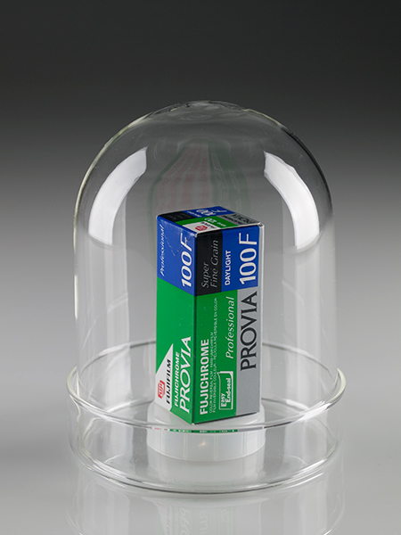 Un rollo de película Fujichrome Provia 100F 120 bajo una urna de vidrio